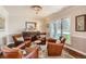 Cozy sitting area with four leather chairs, hardwood floors, and a decorative chandelier at 13 Club Ln, Littleton, CO 80123