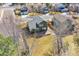 An aerial view of the backyard showcases a wooden deck, mature trees, and a well-maintained lawn at 5051 Yates Cir, Broomfield, CO 80020