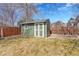 Backyard shed offers extra storage space and complements the fenced yard and garden at 5051 Yates Cir, Broomfield, CO 80020