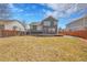 Large backyard featuring a wooden deck and a spacious lawn, perfect for outdoor entertaining and recreation at 5051 Yates Cir, Broomfield, CO 80020