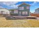 Expansive backyard featuring a spacious deck, lush lawn, and mature landscaping perfect for outdoor entertaining and relaxation at 5051 Yates Cir, Broomfield, CO 80020
