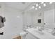 Bright bathroom offers a single sink, a framed mirror, and a bathtub with white tile surround at 5051 Yates Cir, Broomfield, CO 80020