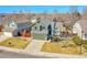 A beautiful two-story home featuring an attached garage, mature landscaping, and a welcoming front porch at 5051 Yates Cir, Broomfield, CO 80020