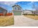 The two-story home features a two-car garage, complemented by professionally landscaped grounds and an inviting entrance at 5051 Yates Cir, Broomfield, CO 80020