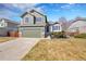 A well-maintained home with a two-car garage, showcases established landscaping, enhancing its curb appeal at 5051 Yates Cir, Broomfield, CO 80020