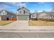A well-maintained home features a two-car garage, manicured lawn, and established landscaping at 5051 Yates Cir, Broomfield, CO 80020