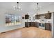 Modern kitchen featuring stainless steel appliances, stylish light fixtures, and hardwood floors at 5051 Yates Cir, Broomfield, CO 80020