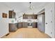Well-lit kitchen with stainless steel appliances, modern cabinetry, and hardwood floors at 5051 Yates Cir, Broomfield, CO 80020