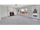 Inviting living room featuring a cozy fireplace, large windows and carpeted floors at 5051 Yates Cir, Broomfield, CO 80020