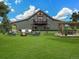 Picturesque backyard showcasing a spacious lawn, outdoor seating area, and beautiful landscaping at 1660 Prominence Cir, Elizabeth, CO 80107