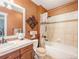Bright bathroom with a tub, a sink with drawers, and patterned wallpaper, providing a cozy and functional space at 1660 Prominence Cir, Elizabeth, CO 80107