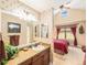 Bathroom that connects to a bedroom, featuring a sink, mirror, and decor with a horse pattern at 1660 Prominence Cir, Elizabeth, CO 80107