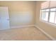 Cozy bedroom with neutral carpet and paint; light streams in from window at 1660 Prominence Cir, Elizabeth, CO 80107