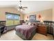Well-lit bedroom with a ceiling fan, large window with outdoor views, and golf themed decor at 1660 Prominence Cir, Elizabeth, CO 80107