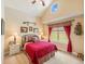 Comfortable bedroom with a window providing scenic views, complemented by a ceiling fan and tasteful decor at 1660 Prominence Cir, Elizabeth, CO 80107