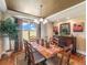 Elegant dining room with coffered ceiling, chandelier, and large window views at 1660 Prominence Cir, Elizabeth, CO 80107