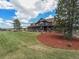 Charming two-story home with landscaped yard, mature trees, and covered porch at 1660 Prominence Cir, Elizabeth, CO 80107
