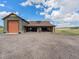 Detached garage and carriage house with gravel driveway and ample parking at 1660 Prominence Cir, Elizabeth, CO 80107