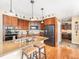 Kitchen with breakfast bar, stainless steel appliances, and wood cabinetry at 1660 Prominence Cir, Elizabeth, CO 80107