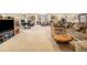 Open living area with plush sectional, wood table, desk, and natural light, great for entertaining and relaxation at 1660 Prominence Cir, Elizabeth, CO 80107