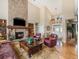 Comfortable living room with stone fireplace, hardwood floors, and vaulted ceiling at 1660 Prominence Cir, Elizabeth, CO 80107