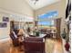 Open concept living room with large windows and scenic views and hardwood floors at 1660 Prominence Cir, Elizabeth, CO 80107