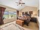 Relaxing main bedroom with a large window, vaulted ceiling, and dark wood furniture at 1660 Prominence Cir, Elizabeth, CO 80107