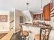 A stylish wet bar with dark wood cabinets, seating, and a staircase to the rest of the home at 1660 Prominence Cir, Elizabeth, CO 80107