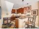 A stylish wet bar with dark wood cabinets, a countertop, and unique slate flooring at 1660 Prominence Cir, Elizabeth, CO 80107