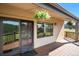 Covered back deck features hanging plants, forest views, and easy access to indoor living spaces at 6880 Kilimanjaro Dr, Evergreen, CO 80439