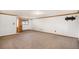 Spacious finished basement offers flexible living space with plush carpet and natural wood trim at 6880 Kilimanjaro Dr, Evergreen, CO 80439