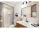 Bright bathroom features updated vanity, shower and modern finishes at 6880 Kilimanjaro Dr, Evergreen, CO 80439