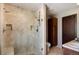 Tiled shower with glass door, built in niche and seat, and modern fixtures at 6880 Kilimanjaro Dr, Evergreen, CO 80439