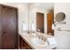 Bathroom featuring double sinks, ample counter space, and large mirror at 6880 Kilimanjaro Dr, Evergreen, CO 80439