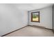 Bedroom featuring carpet, neutral colors, and a window with a scenic view at 6880 Kilimanjaro Dr, Evergreen, CO 80439