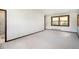 Bright bedroom featuring carpet, large window and neutral color palette at 6880 Kilimanjaro Dr, Evergreen, CO 80439