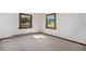 Bedroom featuring carpet, neutral colors, and large windows at 6880 Kilimanjaro Dr, Evergreen, CO 80439