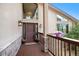 Inviting front entrance with a porch, stone accents, and a glimpse of the interior chandelier at 6880 Kilimanjaro Dr, Evergreen, CO 80439