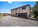 Exterior view of house with attached garage and ample parking space at 6880 Kilimanjaro Dr, Evergreen, CO 80439