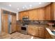 Charming kitchen featuring knotty wood cabinets, granite countertops, and stainless steel appliances at 6880 Kilimanjaro Dr, Evergreen, CO 80439
