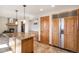 Spacious kitchen with custom wood cabinetry, stone countertops and modern appliances at 6880 Kilimanjaro Dr, Evergreen, CO 80439
