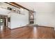 Spacious living room with stone fireplace, wood beams, and an open loft at 6880 Kilimanjaro Dr, Evergreen, CO 80439