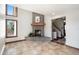 Inviting living room features stone fireplace, tiled floors, and large windows for natural light at 6880 Kilimanjaro Dr, Evergreen, CO 80439