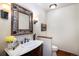 Elegant powder room with marble countertop, decorative mirror, and stylish lighting at 6880 Kilimanjaro Dr, Evergreen, CO 80439