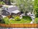 Aerial view showcasing a home with a fenced backyard, patio, firepit, and mature landscaping at 1333 W Peakview Ave, Littleton, CO 80120