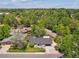 Aerial view of a charming home nestled among lush greenery with mature landscaping and a well-kept lawn at 1333 W Peakview Ave, Littleton, CO 80120