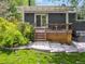 A cozy outdoor patio with a seating area is attached to the home and surrounded by lush greenery, perfect for relaxing at 1333 W Peakview Ave, Littleton, CO 80120