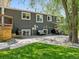 Spacious backyard featuring grass, a stone patio, and the rear of the home at 1333 W Peakview Ave, Littleton, CO 80120