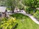 Aerial view of a backyard with a well-manicured lawn, stone firepit, and mature trees offers a private outdoor retreat at 1333 W Peakview Ave, Littleton, CO 80120