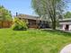 Spacious backyard featuring grass, a stone patio, and the rear of the home at 1333 W Peakview Ave, Littleton, CO 80120